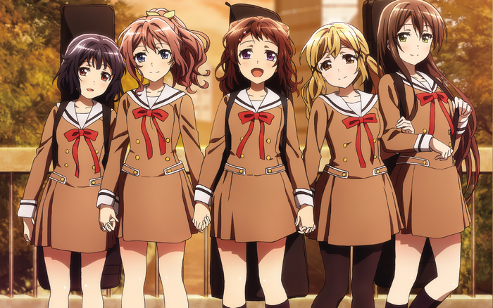 Five girls in school uniforms with musical instruments