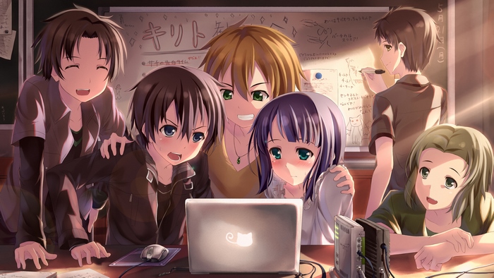 Group of friends gathered around a laptop