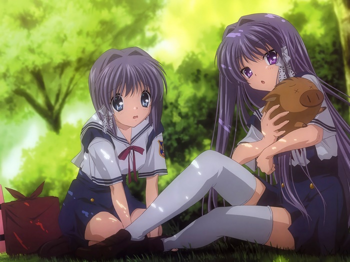 Two girls in school uniforms in a park