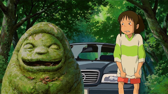 Chihiro and a moss-covered statue in Spirited Away