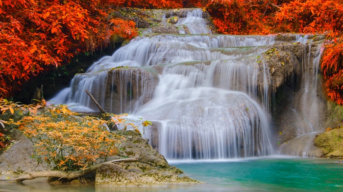 Tiered waterfall with orange foliage and turquoise pool