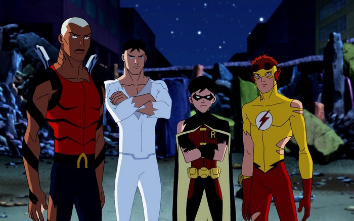 Four superheroes standing in a destroyed city
