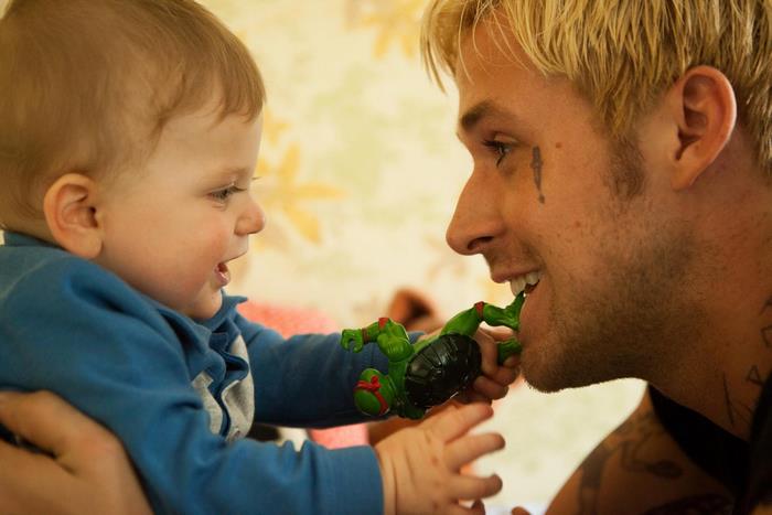 Luke from The Place Beyond the Pines with a baby