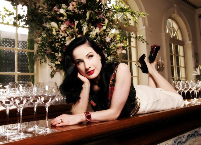 Dita Von Teese lying on a bar