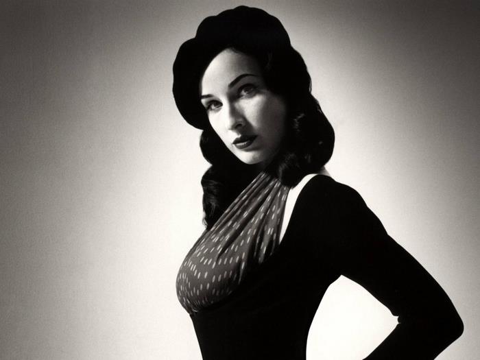 Dita Von Teese in a black dress and hat