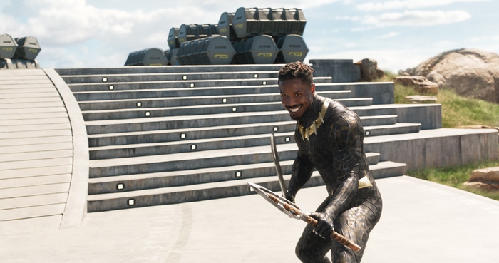 Erik Killmonger from Black Panther holding weapons