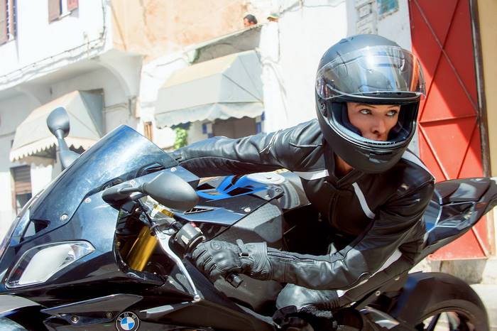 Ilsa Faust on a BMW motorcycle