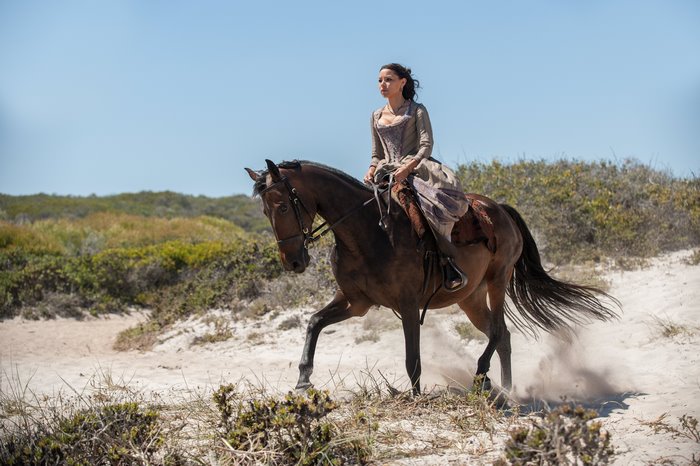 Anne Bonny from Black Sails riding a horse