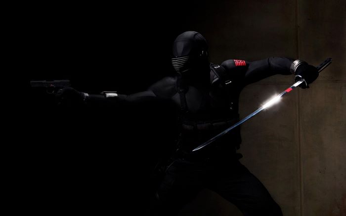 Snake Eyes holding a pistol and sword