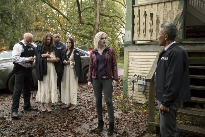 Liv Moore and police officers at a house