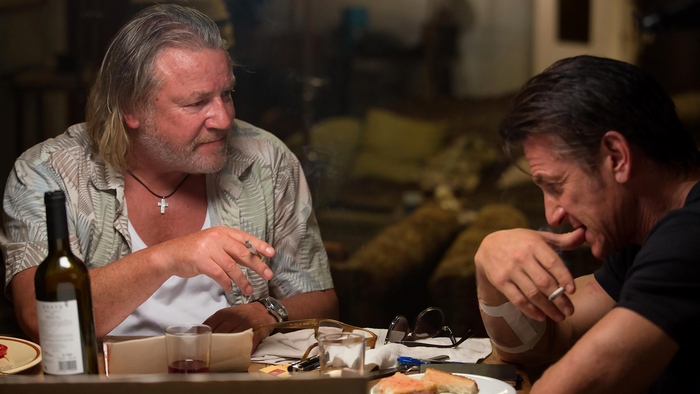 Sean Penn and another man at a table