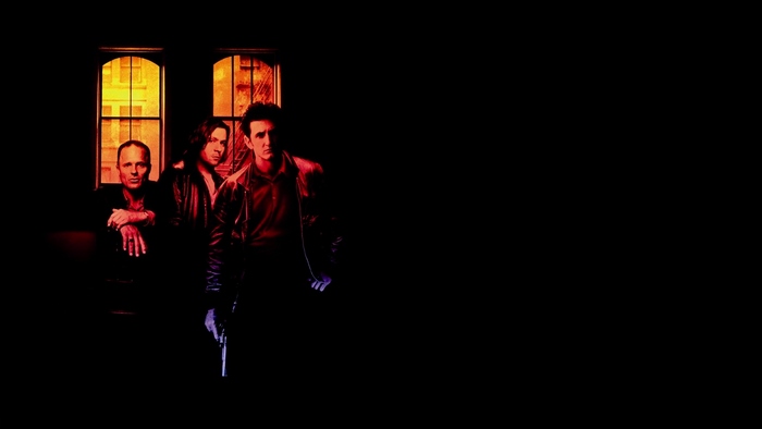 Sean Penn and two men in front of windows