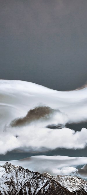 Snowy mountains under dramatic clouds