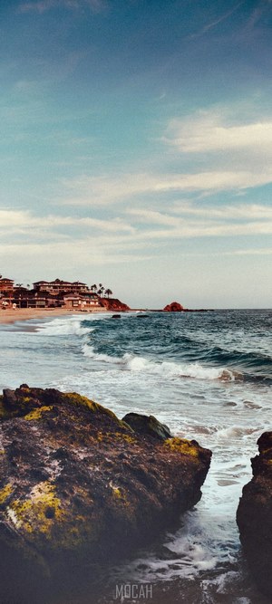 Beach with buildings and ocean waves