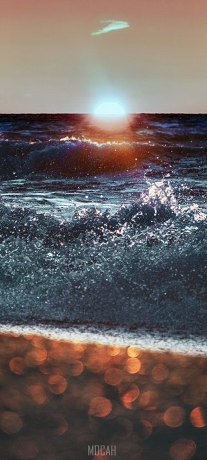 Sunset over the ocean with waves