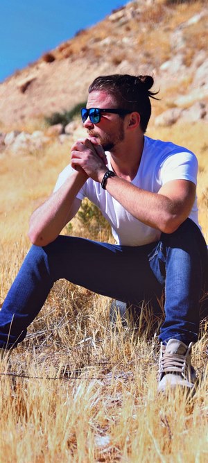 Man with bun hairstyle wearing sunglasses and white t-shirt