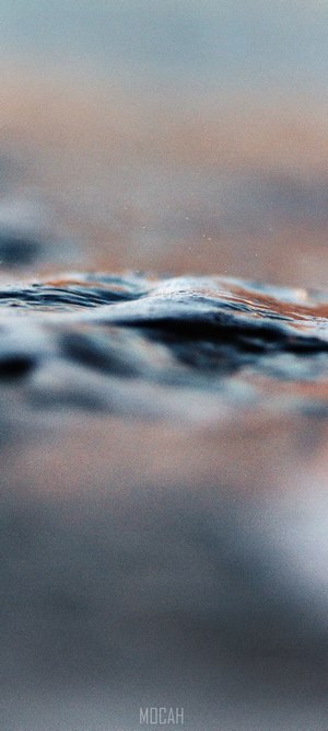 Close-up of water surface with sunset colors