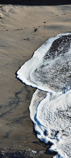 Ocean waves washing over a sandy beach
