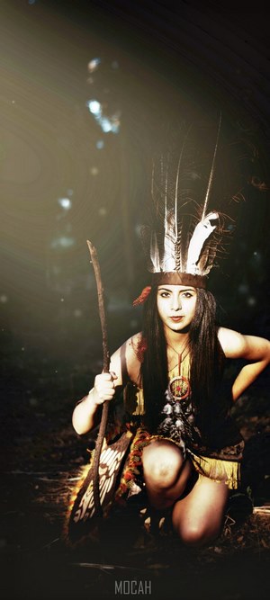 Woman in Native American Costume Holding a Stick