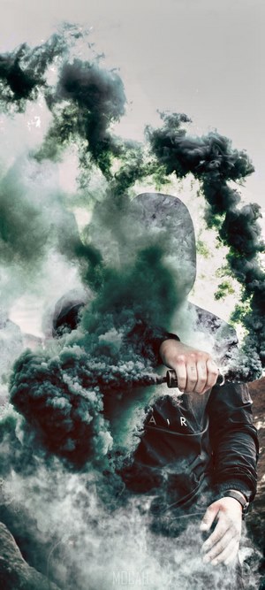 Person holding smoke grenade in dark clothing