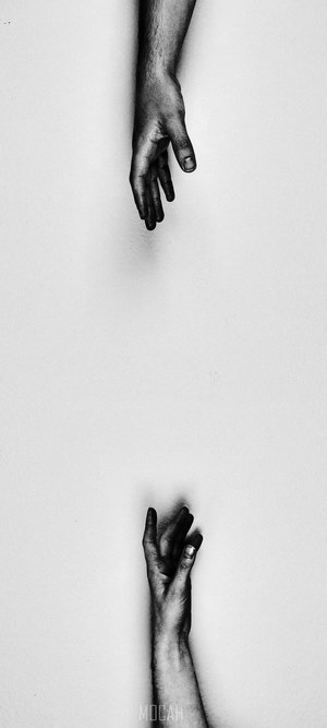 Two hands reaching for each other
