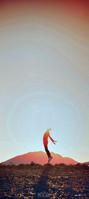 Silhouette of a person jumping against a sunset