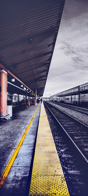 Train station platform with trains and tracks