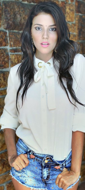 Woman in white shirt and denim shorts