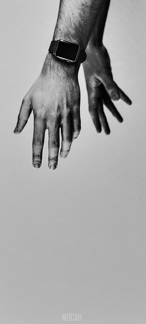 Person wearing Apple Watch, monochrome hands