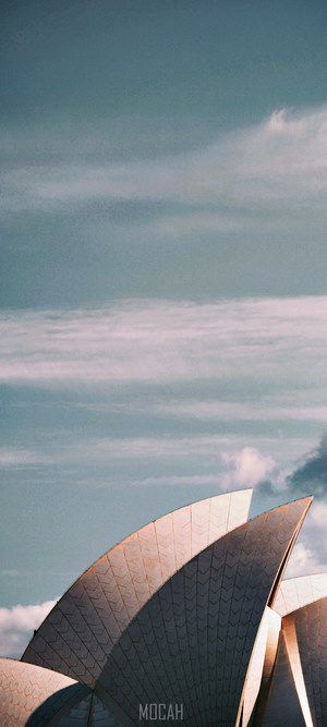 Sydney Opera House sails against a cloudy sky