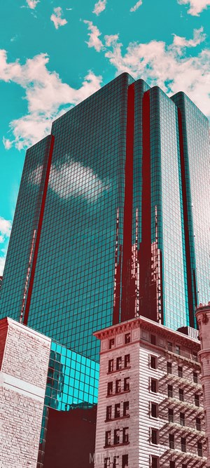 Reflective office building against a turquoise sky