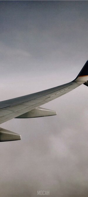 Airplane wing over clouds