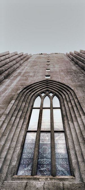 Tall concrete building with arched window