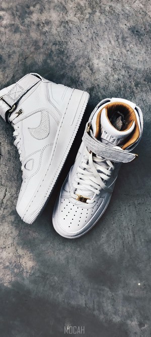White Nike Air Force 1 High-Top Sneakers on Concrete