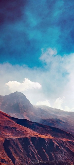 Steep slopes of rocky mountains under azure sky
