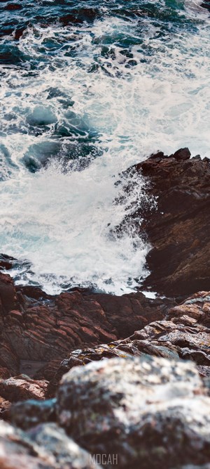 Ocean waves crashing on rocky shore