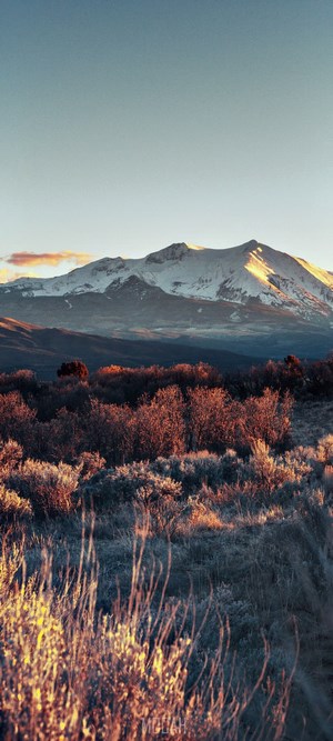 Sunlit Snow-Capped Mountain at Dawn