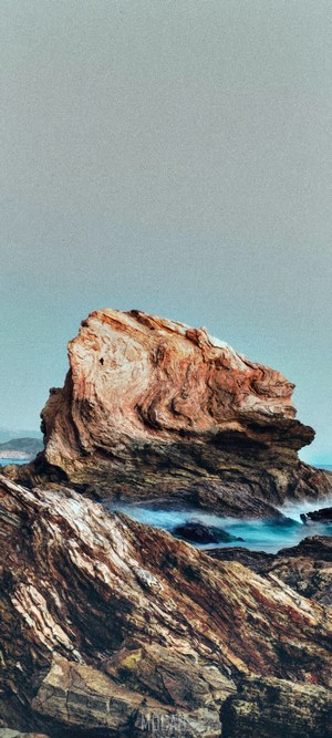 Rock formation in the ocean with waves