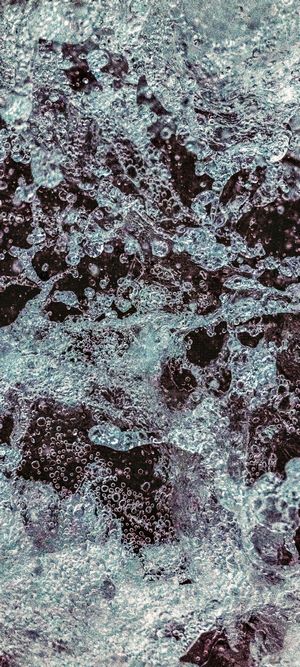 Abstract blue and dark water surface with bubbles