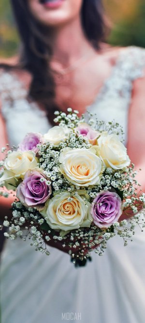 Bride holding a bouquet of roses