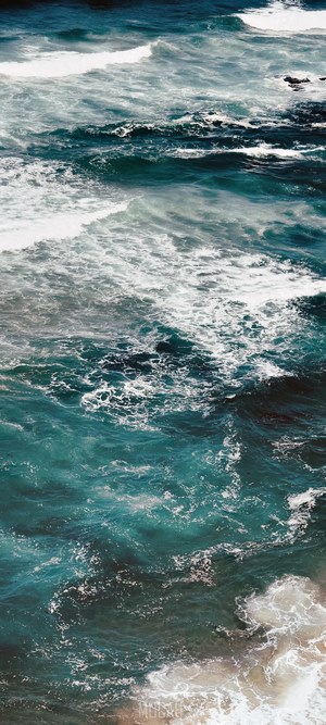 Ocean waves crashing on a sandy beach
