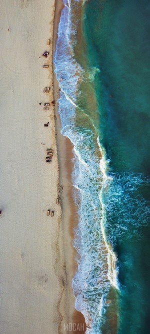Aerial view of a beach with turquoise water and waves