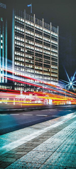 City building with light trails at night