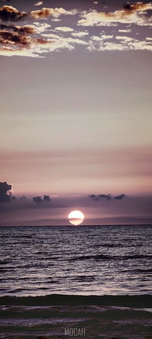 Sunset over the ocean with clouds