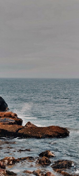 Ocean waves crashing on rocky shore