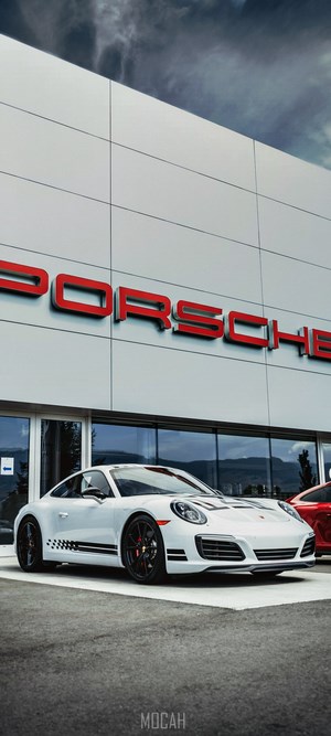 White Porsche 911 with Racing Stripes at Dealership