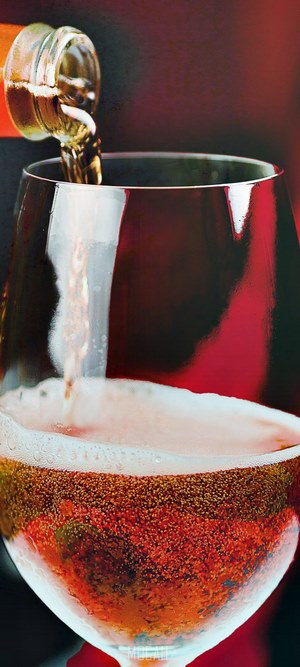 Beer being poured into a glass with foam