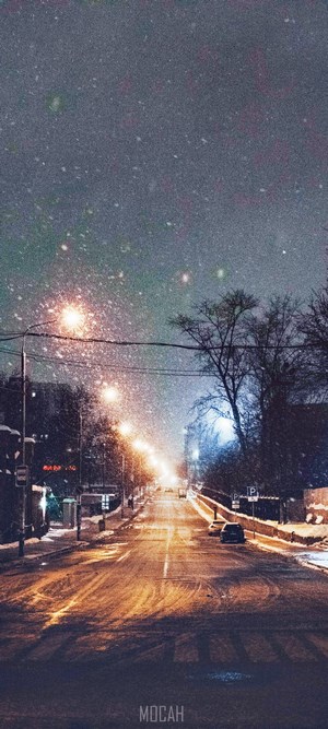 Snowy street at night with street lights