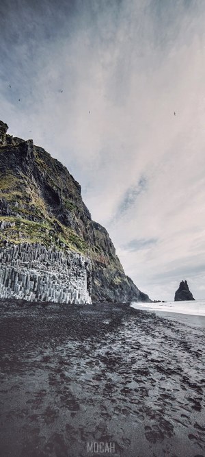 Reynisfjara black sand beach with basalt columns and sea stack