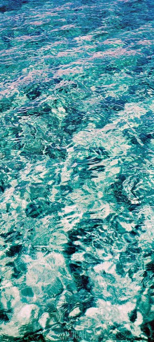 Turquoise water with ripples and light reflections